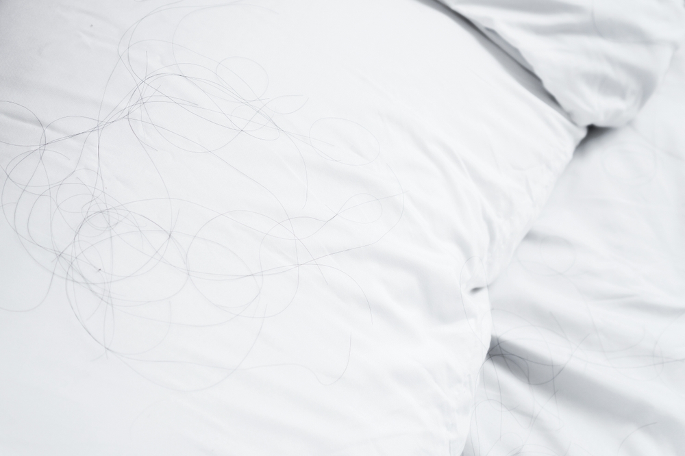 Hair strands on pillow after poor sleep